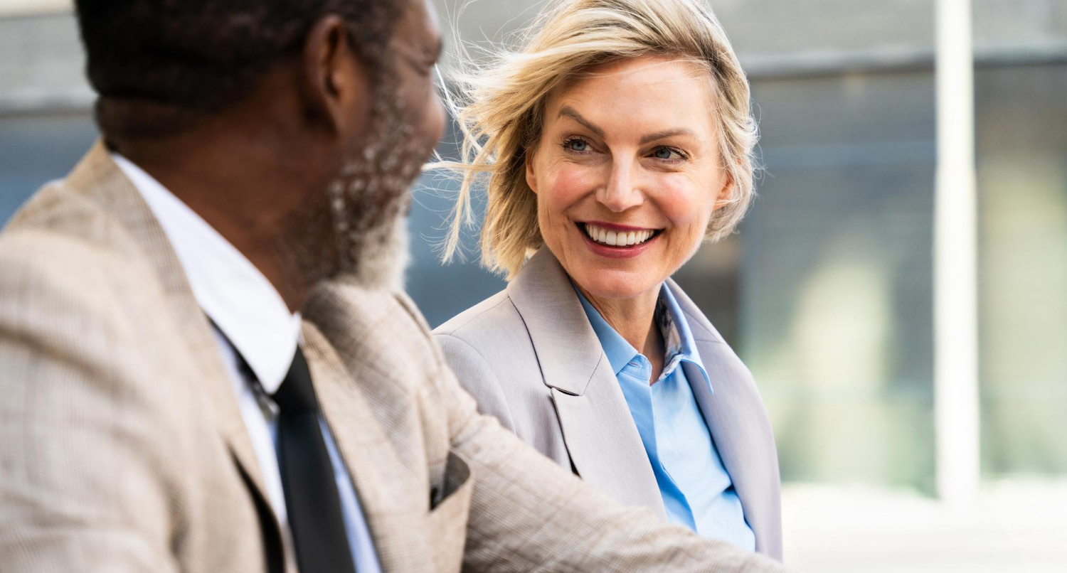 Two senior professionals in conversation